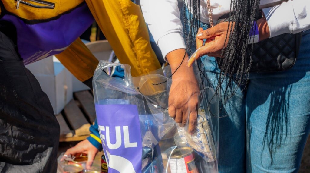 volunteers packing grocery bags for donation