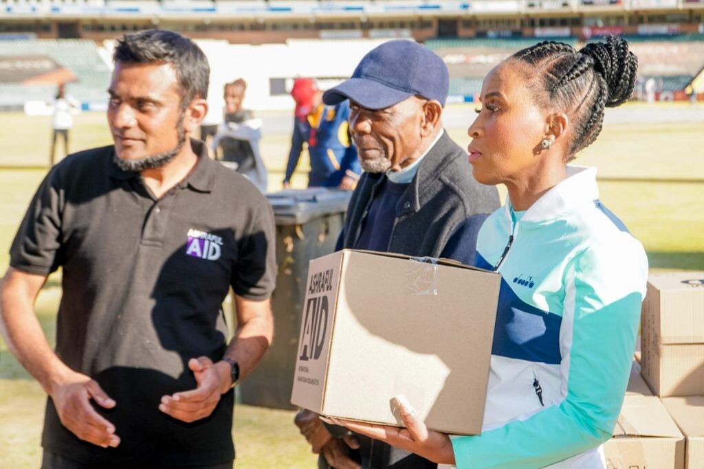 Player assisting AshrafulAid in delivering humanitarian aid during Mandela Day initiatives