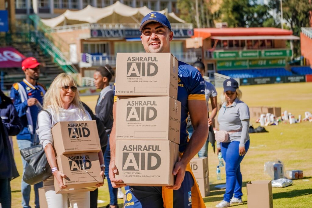 AshrafulAid and sports player collaborating to distribute aid on Mandela Day