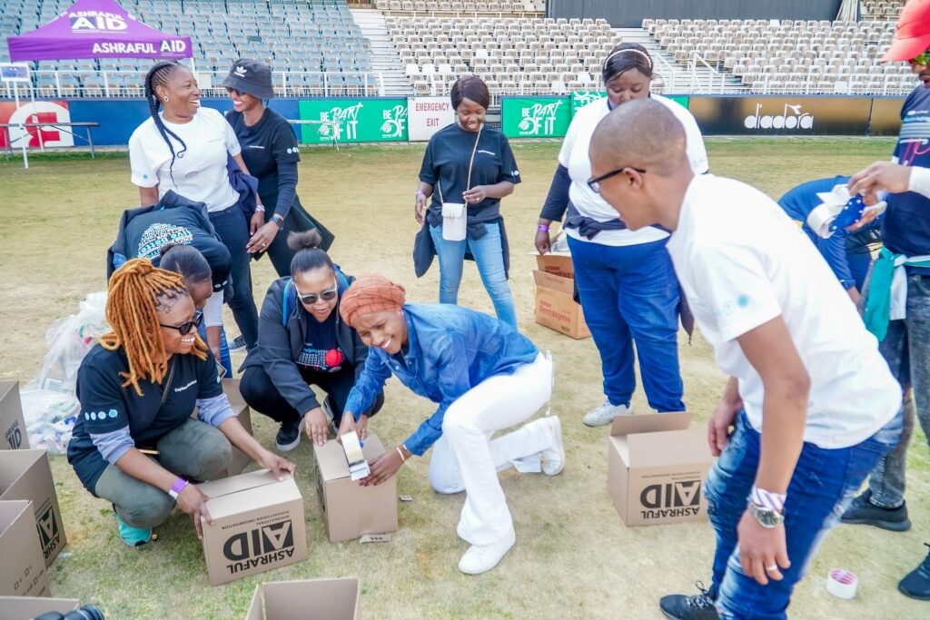 AshrafulAid staff and volunteers assembling grocery donation bags
