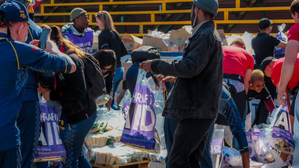 AshrafulAid volunteers packing grocery bags with food and essentials