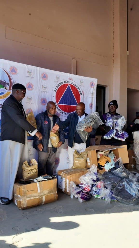 Ashraful Aid representatives handing relief parcels to Alfred Nzo Disaster Management officials